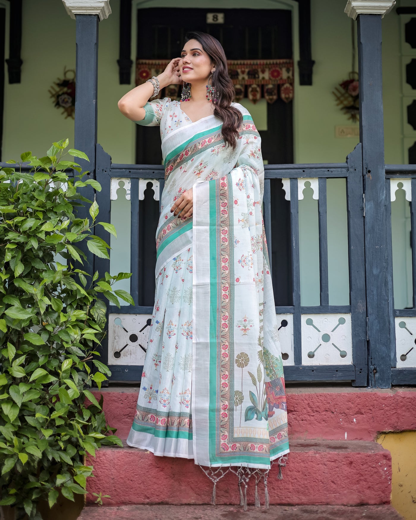 Ivory Pure Cotton Linen Saree with Elephant Motif and Floral Pattern, Green and Pink Borders, and Tassels on Edges.