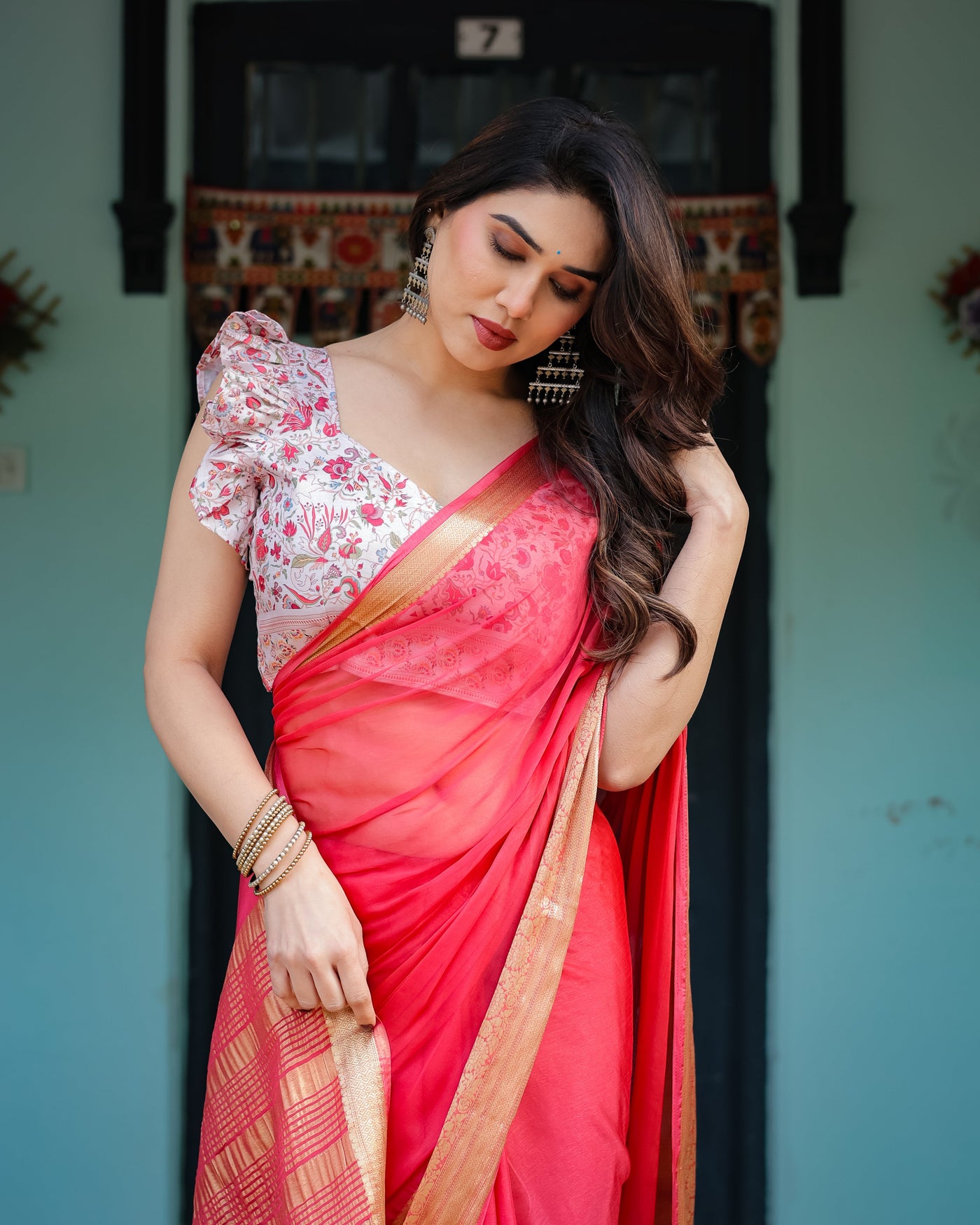 Vibrant Coral Pink Plain Chiffon Saree with Gold Zari Border, Floral Ruffled Blouse & Tassel Detailing