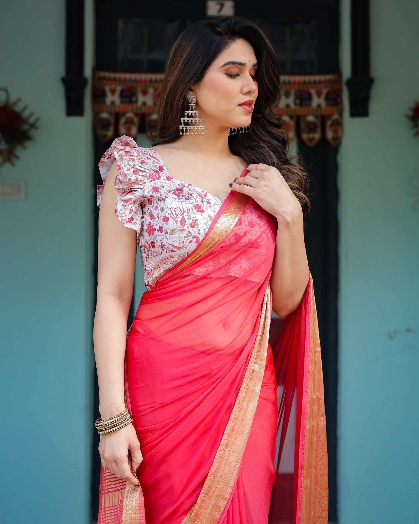 Vibrant Coral Pink Plain Chiffon Saree with Gold Zari Border, Floral Ruffled Blouse & Tassel Detailing