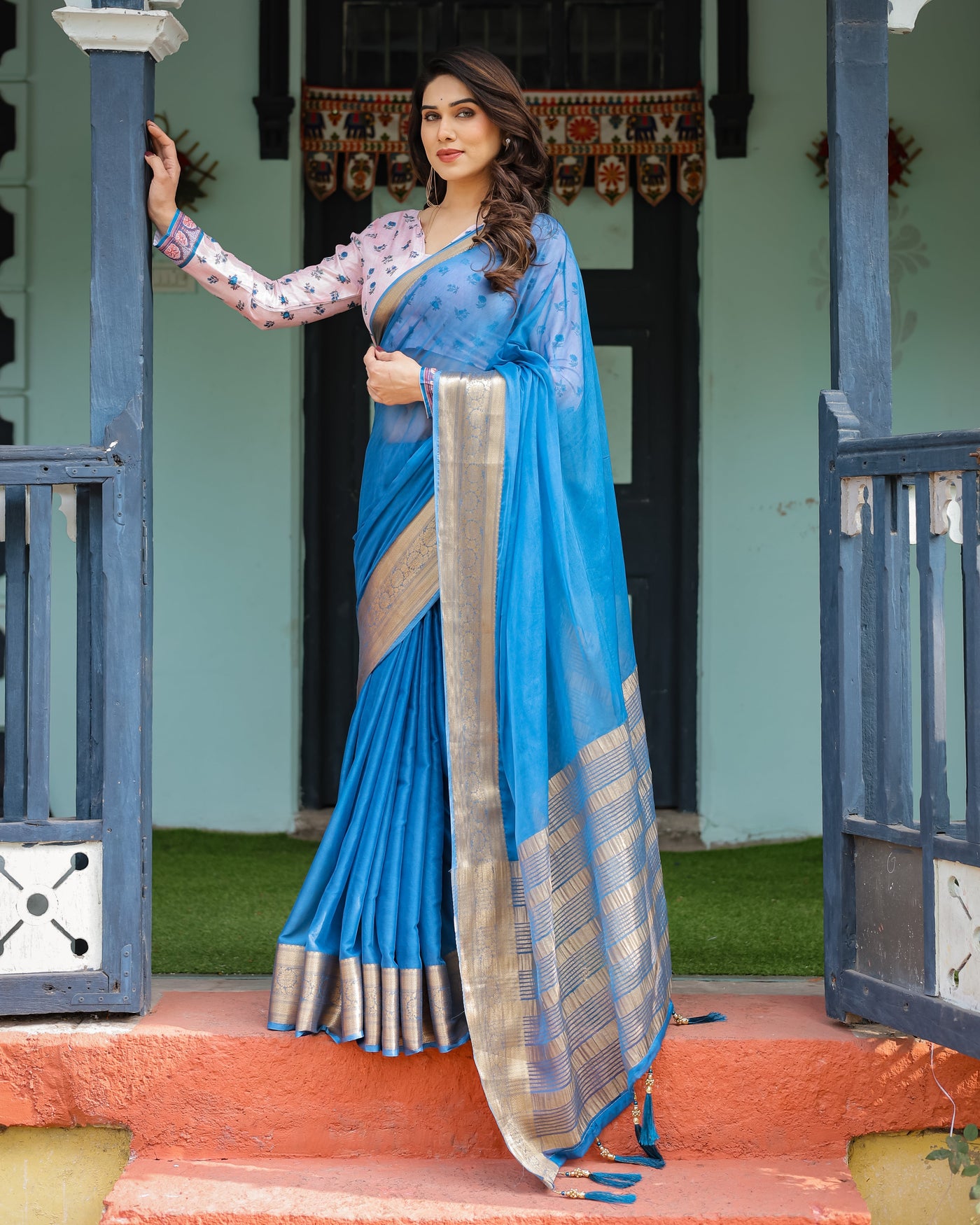 Vibrant Sky Blue Plain Chiffon Saree with Gold Zari Border, Floral Printed Blouse & Tassel Accents