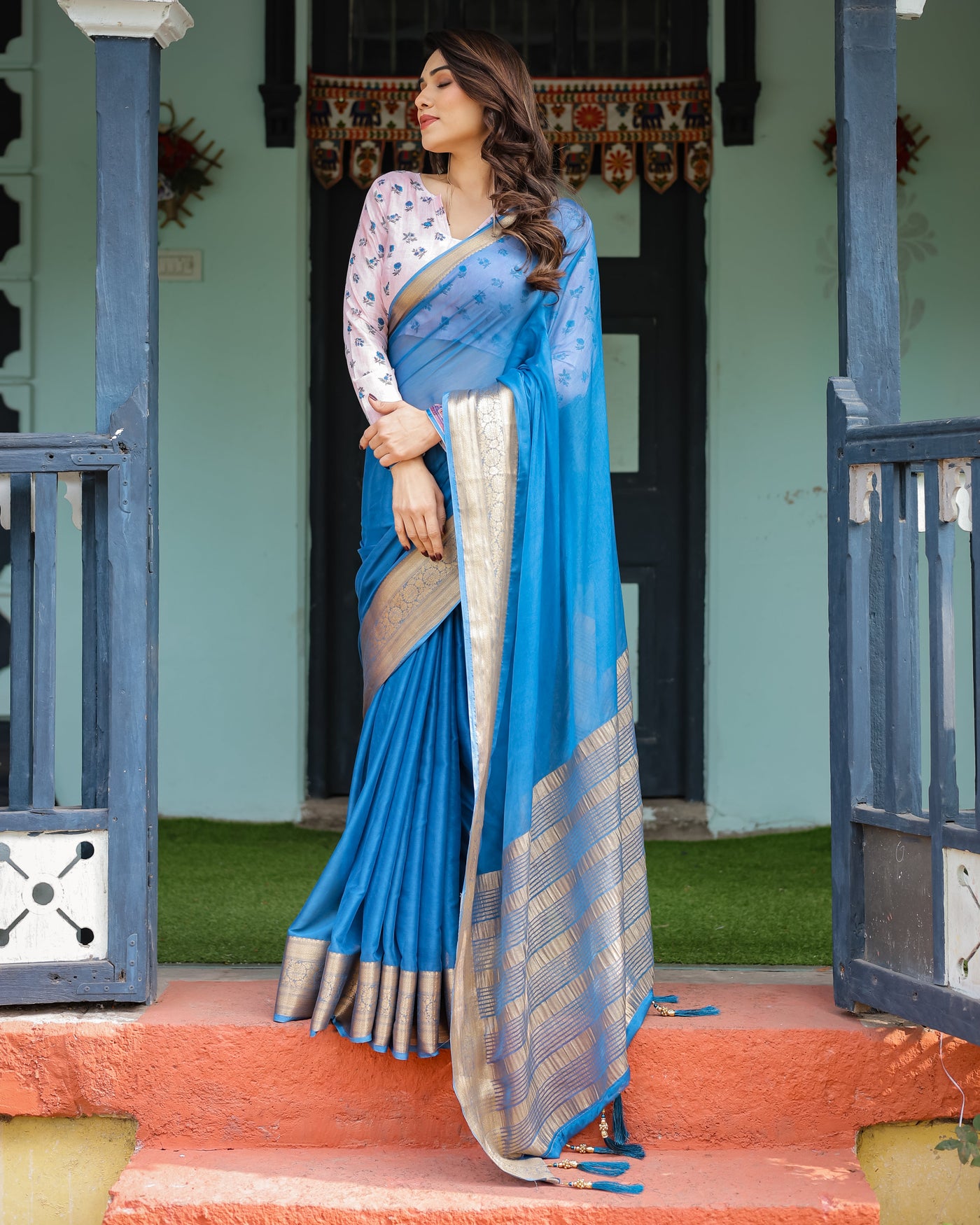 Vibrant Sky Blue Plain Chiffon Saree with Gold Zari Border, Floral Printed Blouse & Tassel Accents