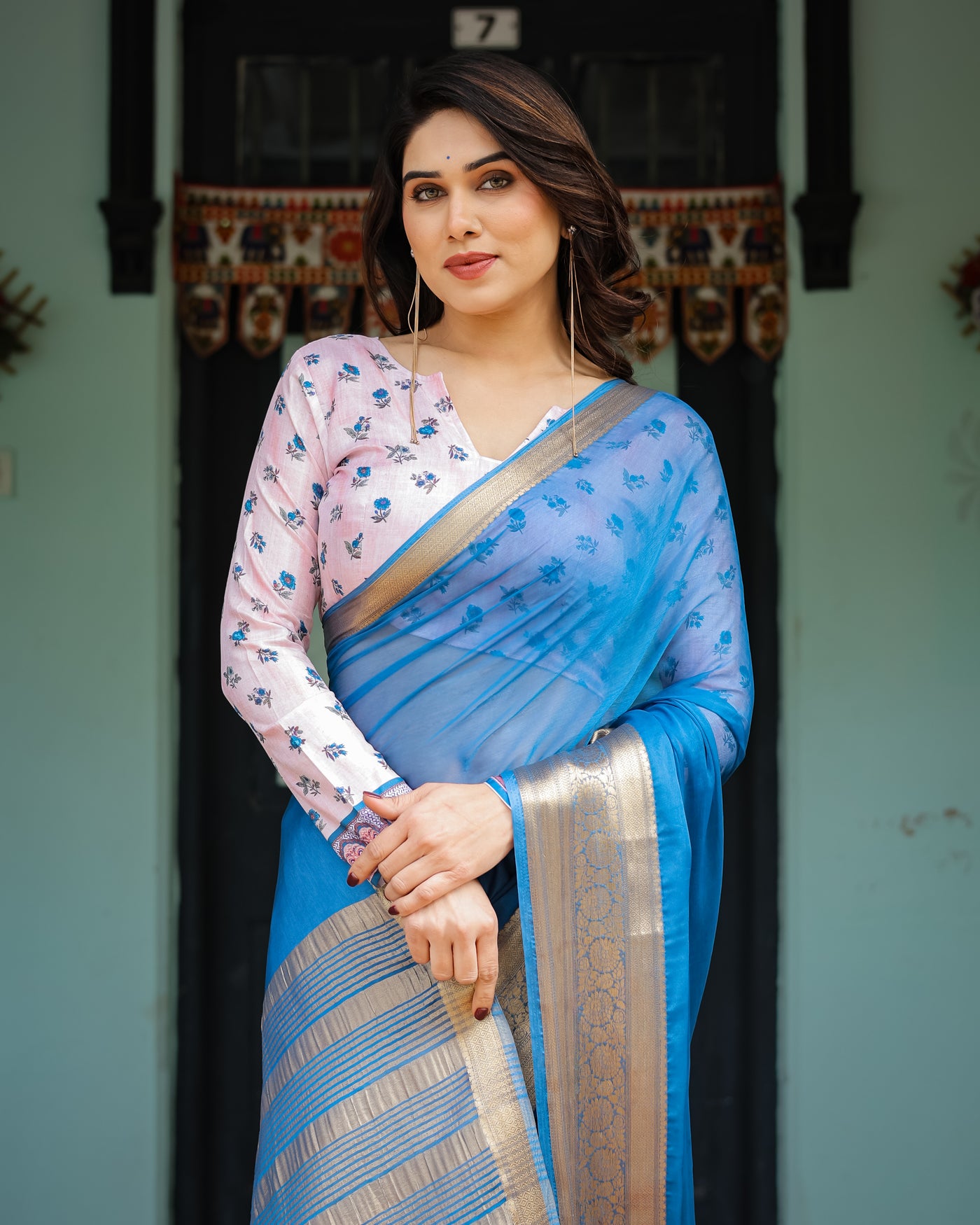 Vibrant Sky Blue Plain Chiffon Saree with Gold Zari Border, Floral Printed Blouse & Tassel Accents