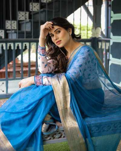 Vibrant Sky Blue Plain Chiffon Saree with Gold Zari Border, Floral Printed Blouse & Tassel Accents