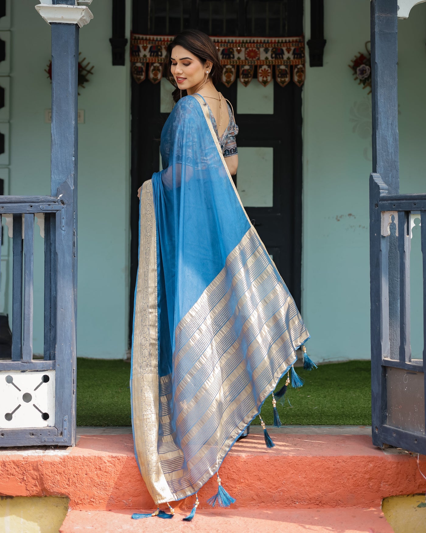 Vibrant Peacock Blue Plain Chiffon Saree with Gold Zari Border, Floral Printed Blouse & Tassel Accents