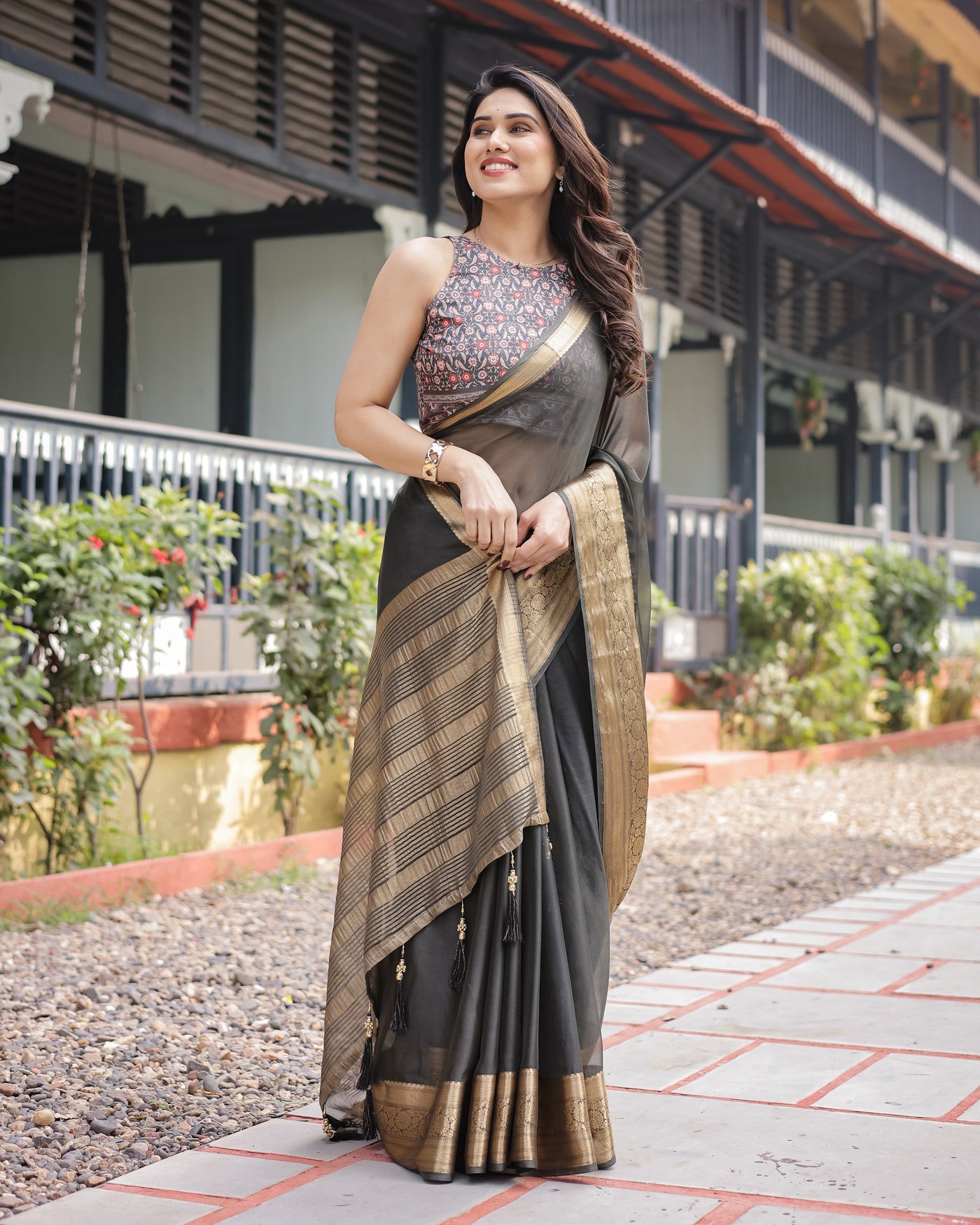 Ethereal Black Plain Chiffon Saree with Gold Zari Border, Floral Printed Blouse & Tassel Detailing