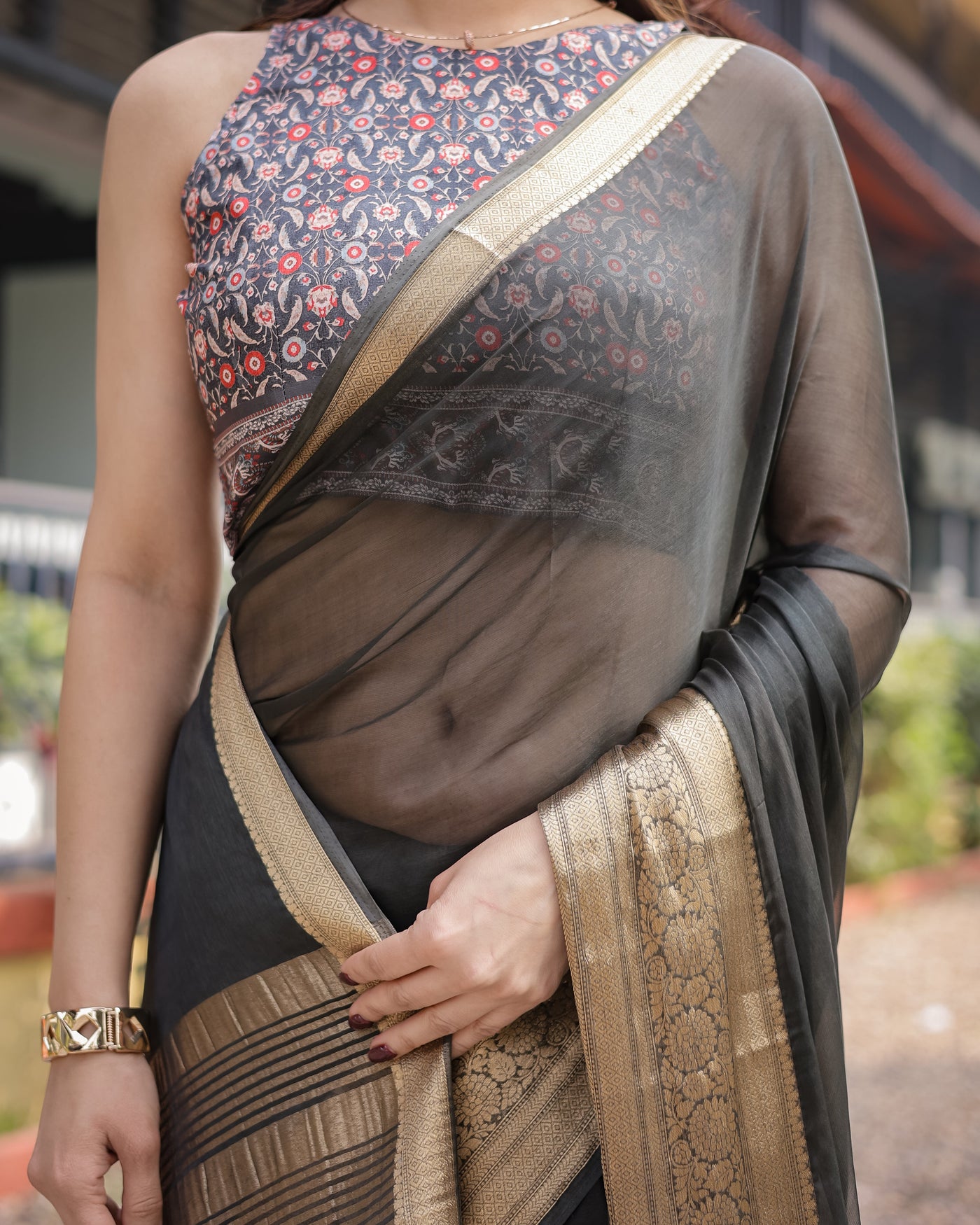 Ethereal Black Plain Chiffon Saree with Gold Zari Border, Floral Printed Blouse & Tassel Detailing