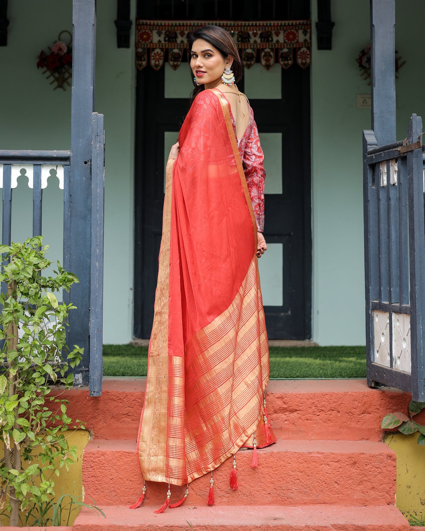 Fiery Red Plain Chiffon Saree with Gold Zari Border, Full-Sleeve Floral Blouse & Tassel Detailing