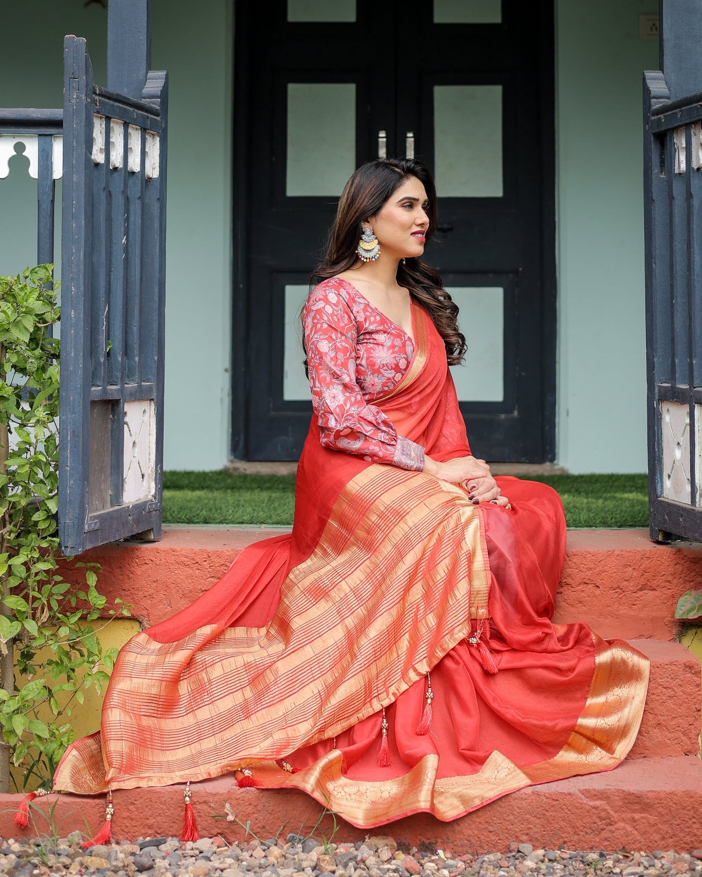 Fiery Red Plain Chiffon Saree with Gold Zari Border, Full-Sleeve Floral Blouse & Tassel Detailing