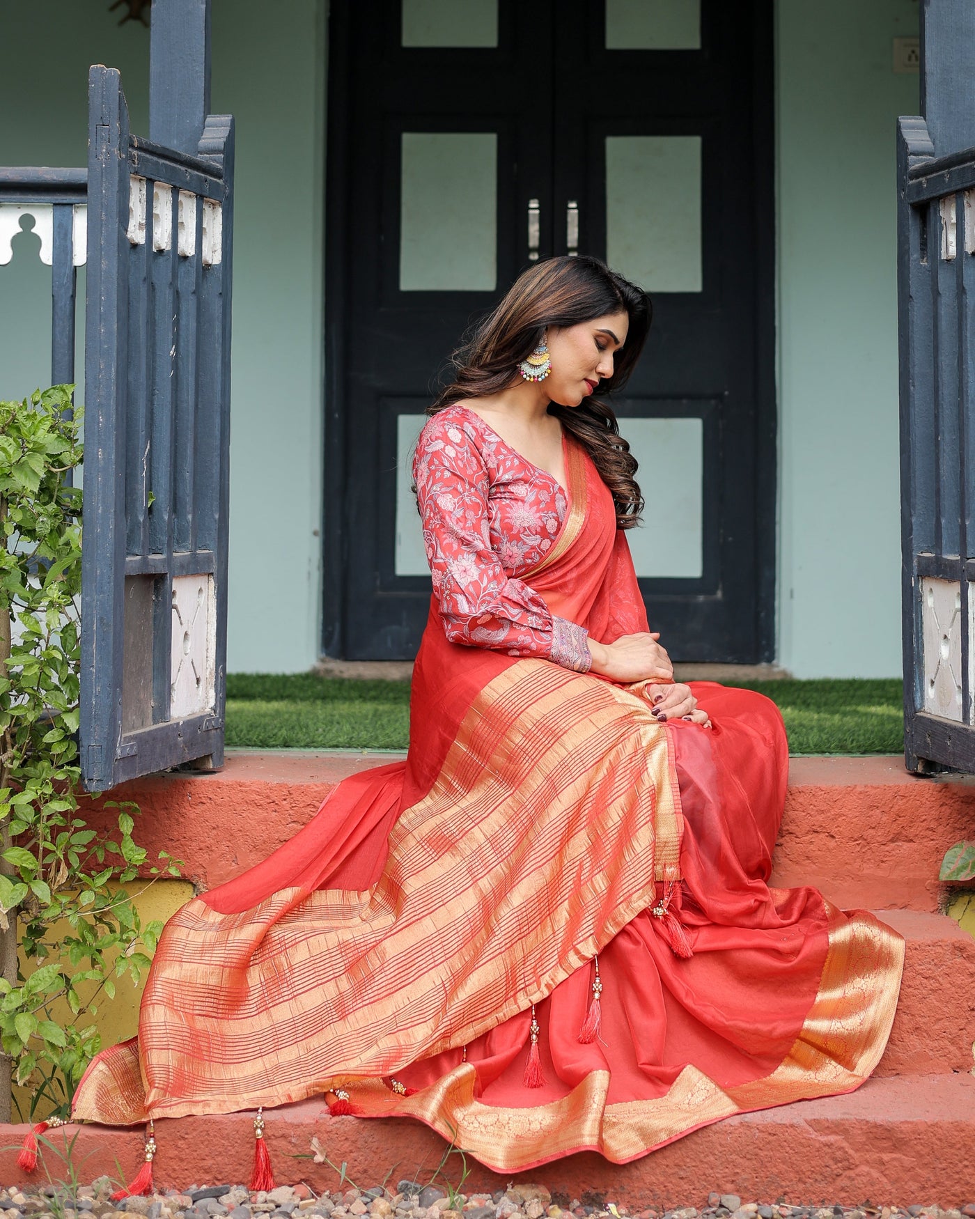 Fiery Red Plain Chiffon Saree with Gold Zari Border, Full-Sleeve Floral Blouse & Tassel Detailing