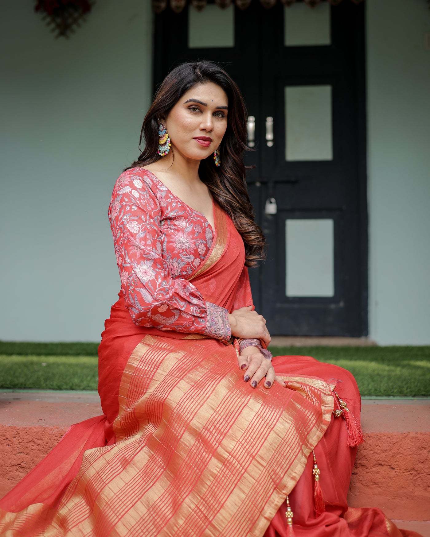 Fiery Red Plain Chiffon Saree with Gold Zari Border, Full-Sleeve Floral Blouse & Tassel Detailing