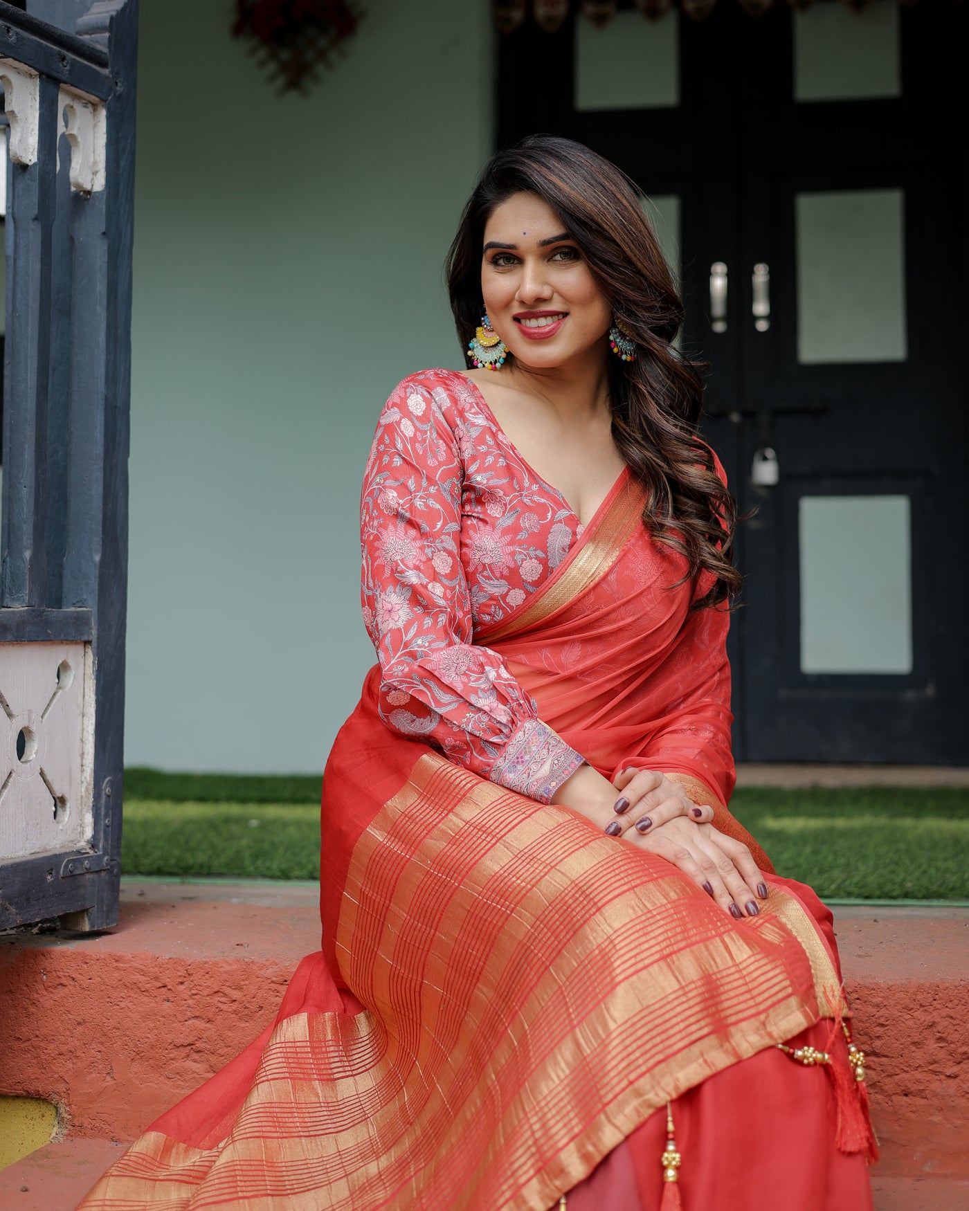 Fiery Red Plain Chiffon Saree with Gold Zari Border, Full-Sleeve Floral Blouse & Tassel Detailing