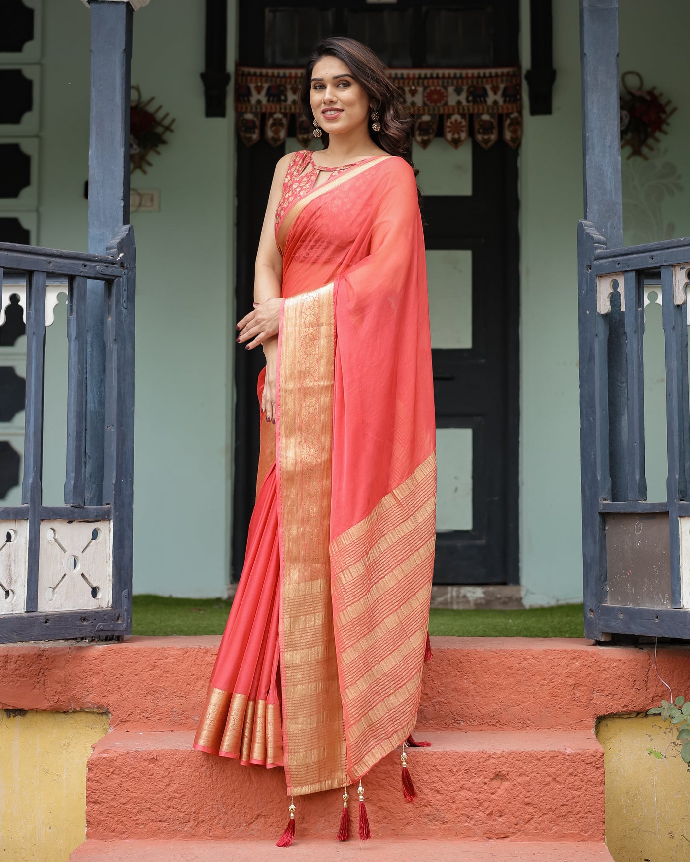 Graceful Coral Pink Plain Chiffon Saree with Gold Zari Border, Floral Embroidered Blouse & Tassel Detailing