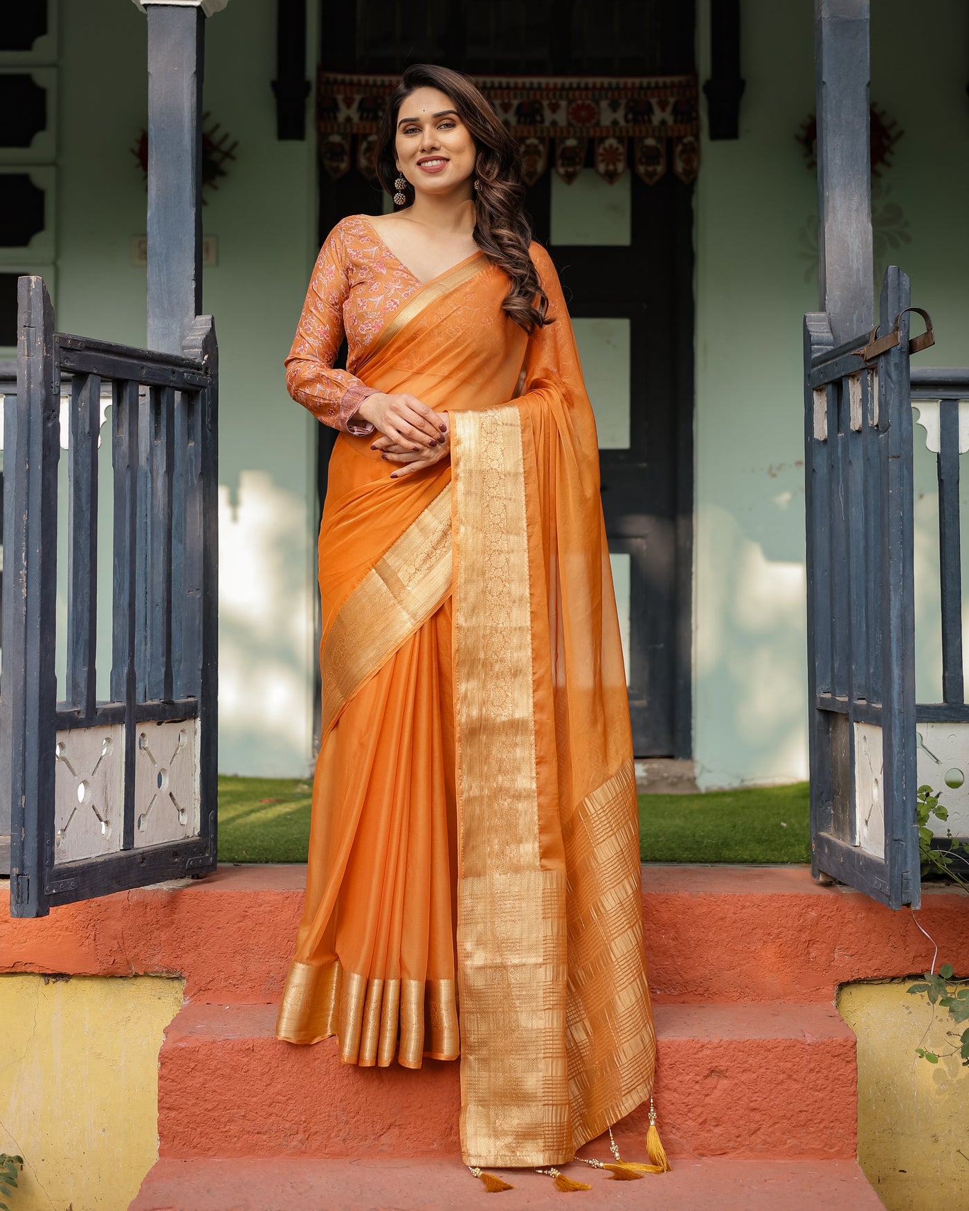 Sunset Orange Plain Chiffon Saree with Gold Zari Border, Floral Embroidered Blouse & Tassel Detailing