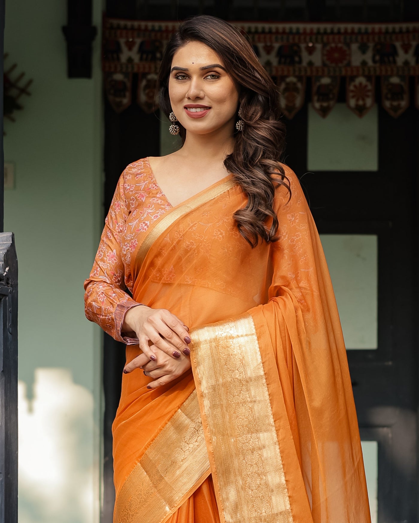 Sunset Orange Plain Chiffon Saree with Gold Zari Border, Floral Embroidered Blouse & Tassel Detailing