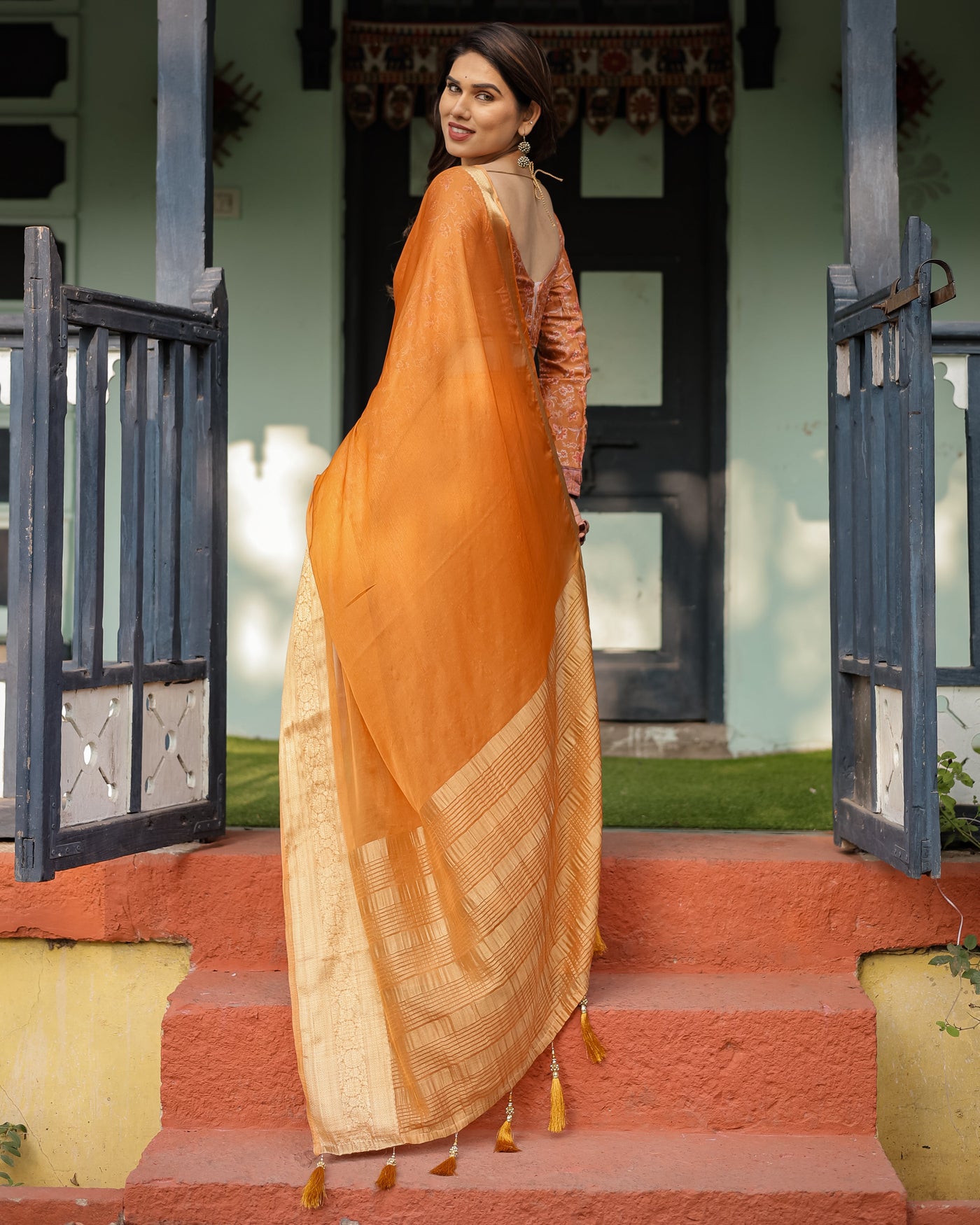 Sunset Orange Plain Chiffon Saree with Gold Zari Border, Floral Embroidered Blouse & Tassel Detailing