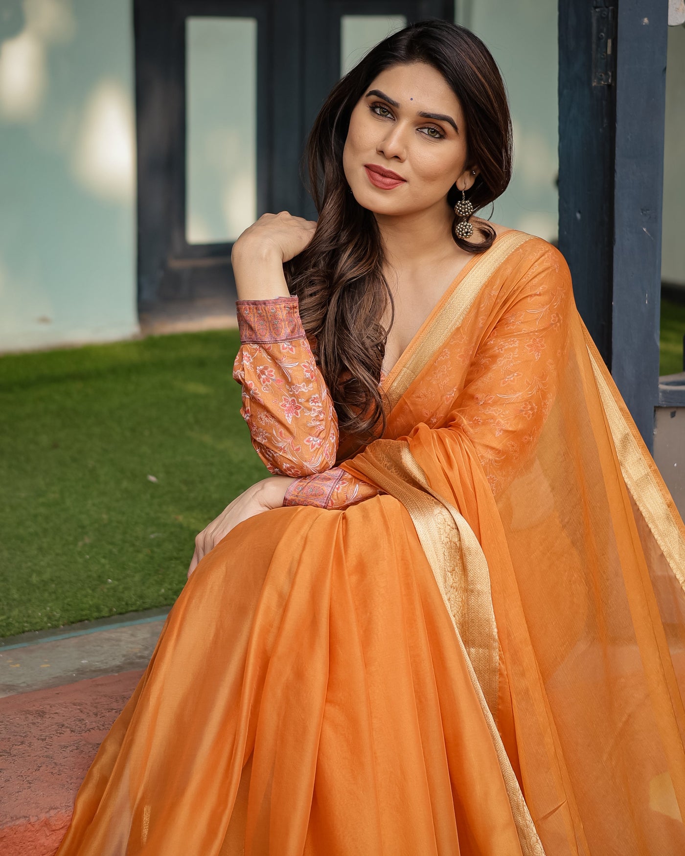 Sunset Orange Plain Chiffon Saree with Gold Zari Border, Floral Embroidered Blouse & Tassel Detailing