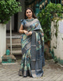 Elegant Teal Blue Banarasi Silk Saree with Forest-Inspired Motifs and Tassels