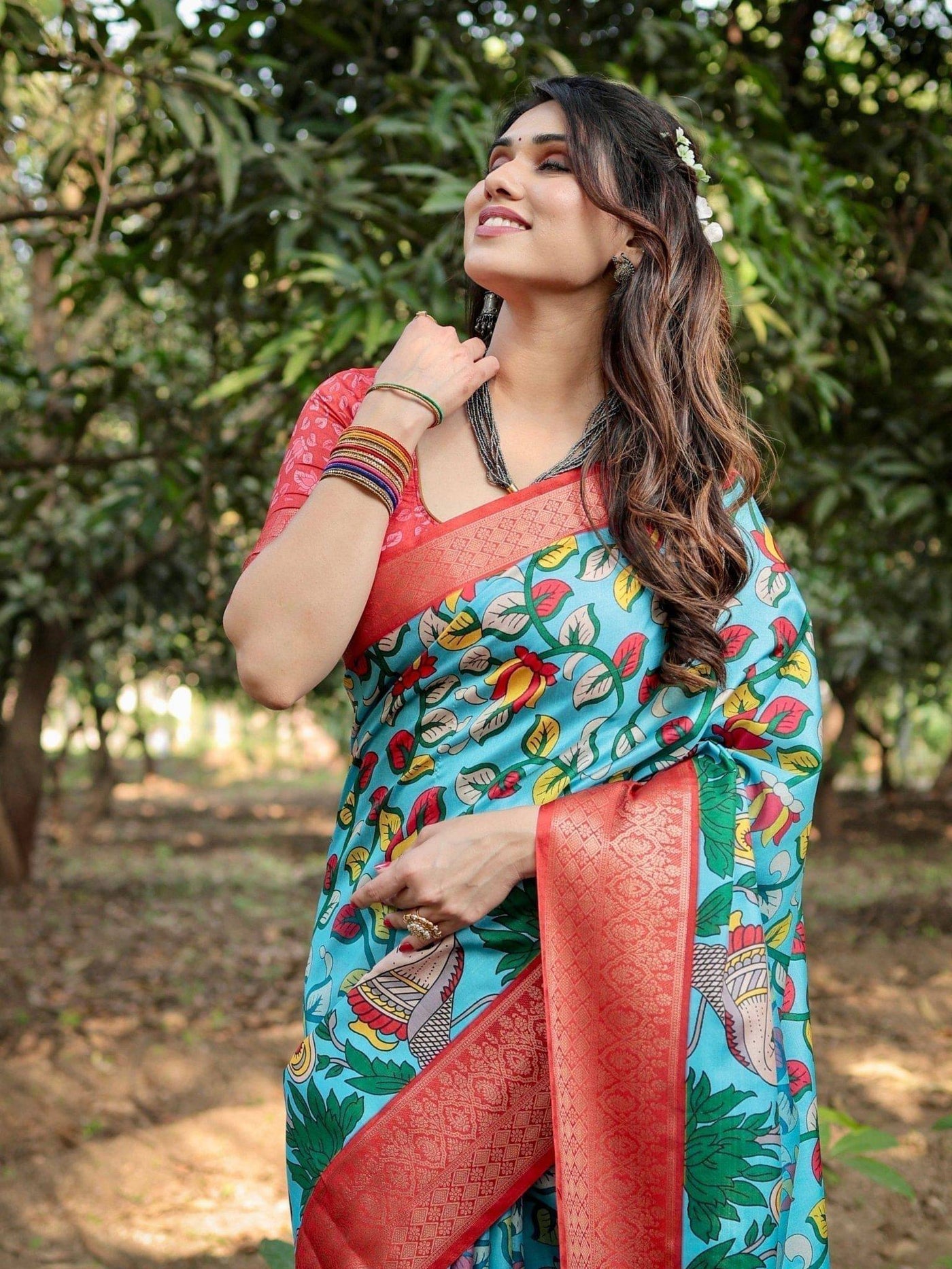 Aqua Blue Banarasi Silk Saree with Vibrant Nature-Inspired Prints and Red Zari Border