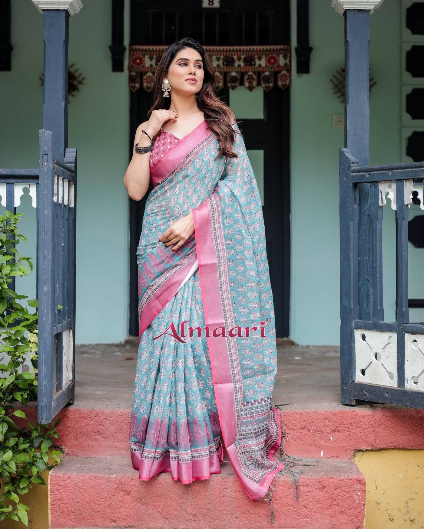 Aqua Blue Pure Cotton Linen Saree with Pink Border, Floral Motifs, and Tassel Detailing