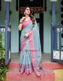 Aqua Blue Pure Cotton Linen Saree with Pink Border, Floral Motifs, and Tassel Detailing