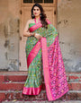 Green and Pink Banarasi Silk Saree with Vibrant Ikat Patterns and Zari Border